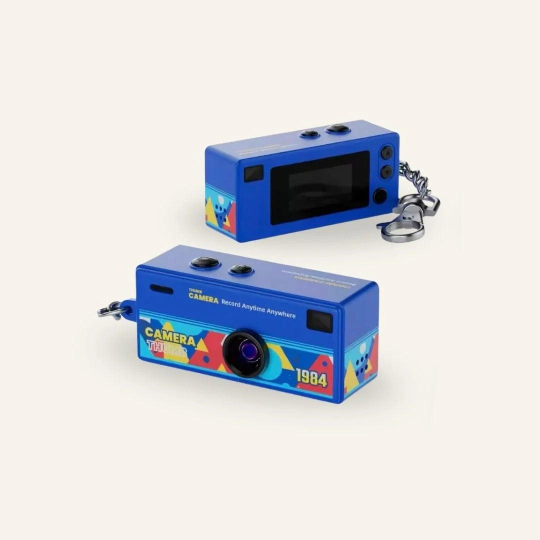 Thumb Camera 1984 keychain camera with its USB-C cable and neck strap