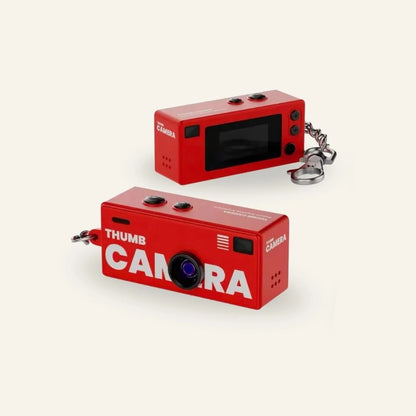 Thumb Camera 1984 retro keychain camera in hand, warm daylight